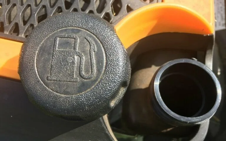 How do I clean the gas cap on my lawn mower?